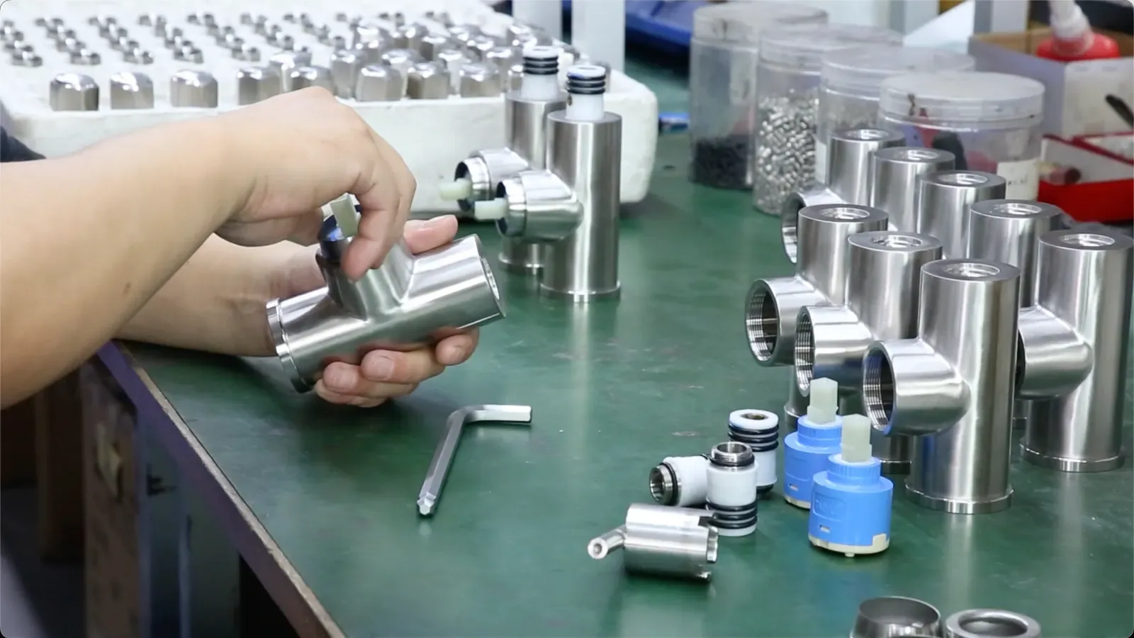 Stainless-steel valve bodies being checked at the assembly bench